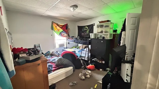 a bathroom with a toilet and a shower curtain