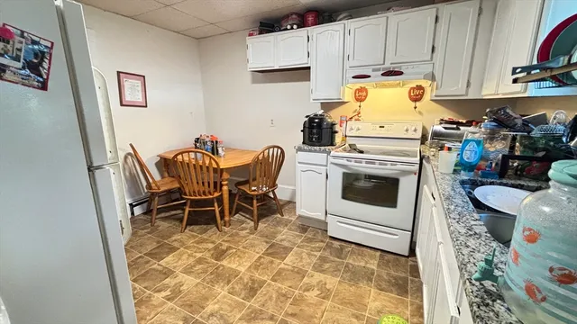 a living room with furniture chess board and a flat screen tv