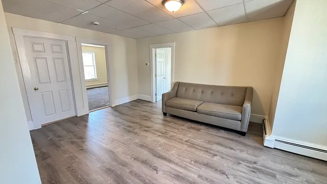 a view of hallway with wooden floor
