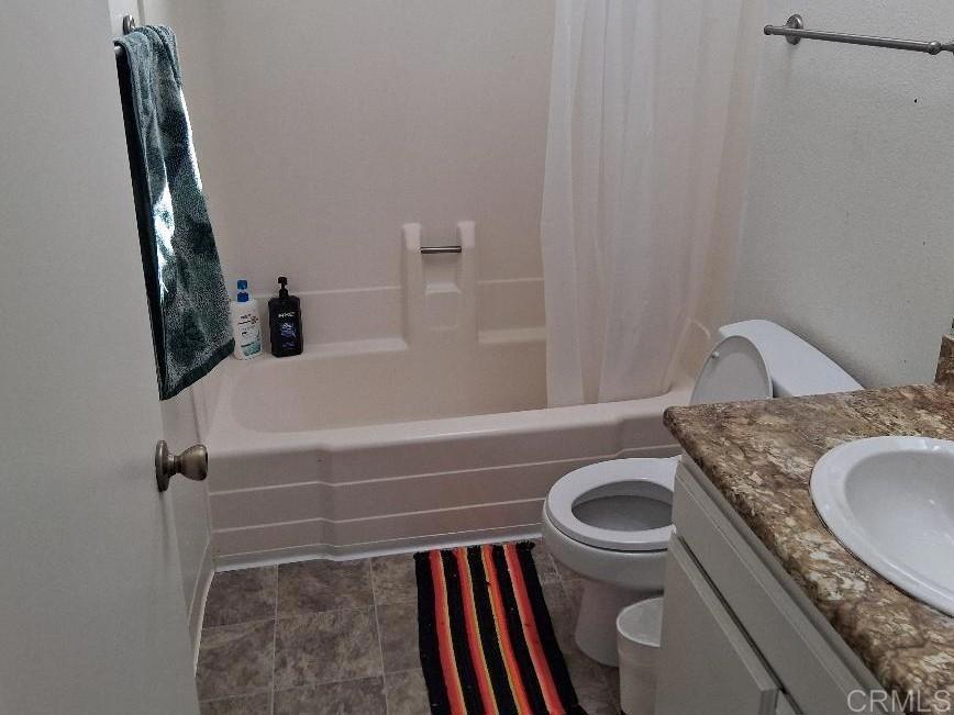 426 Sacramento Avenue Spring Valley, CA 91977 - Photo 12 of 19 a bathroom with a granite countertop sink a toilet and a bathtub