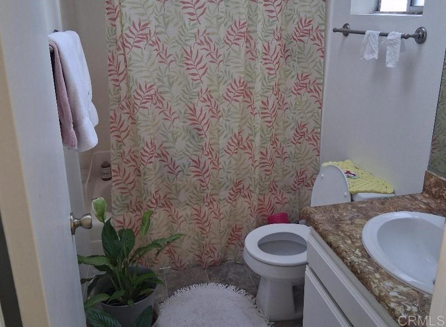 426 Sacramento Avenue Spring Valley, CA 91977 - Photo 13 of 19 a bathroom with a granite countertop toilet and a sink