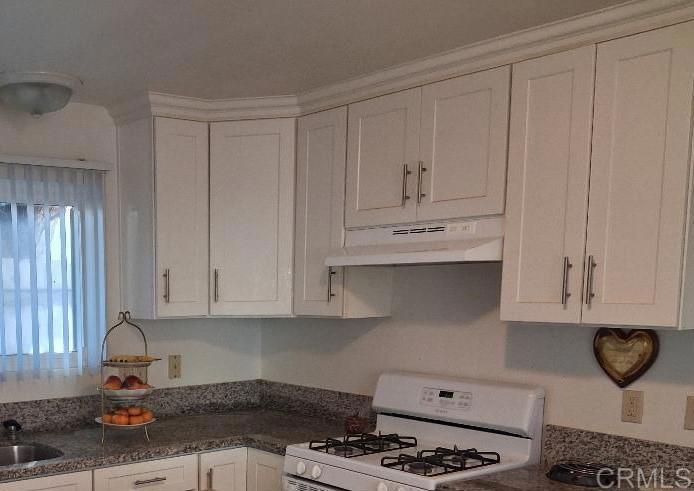 426 Sacramento Avenue Spring Valley, CA 91977 - Photo 9 of 19 a kitchen with white cabinets and appliances