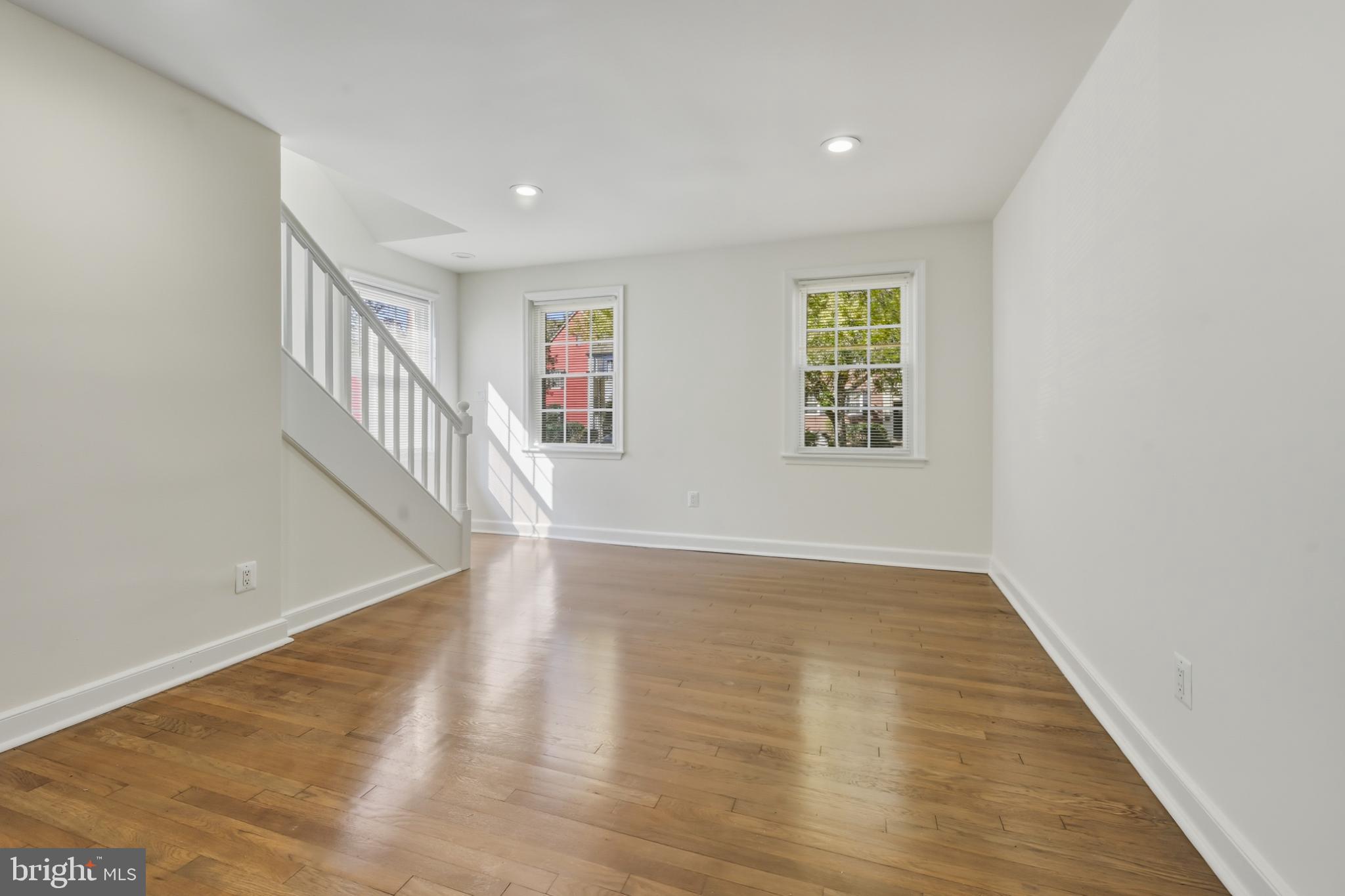 2110 Suitland Terrace Southeast Washington, DC 20020 - Photo 6 of 16 wooden floor in an empty room with a window