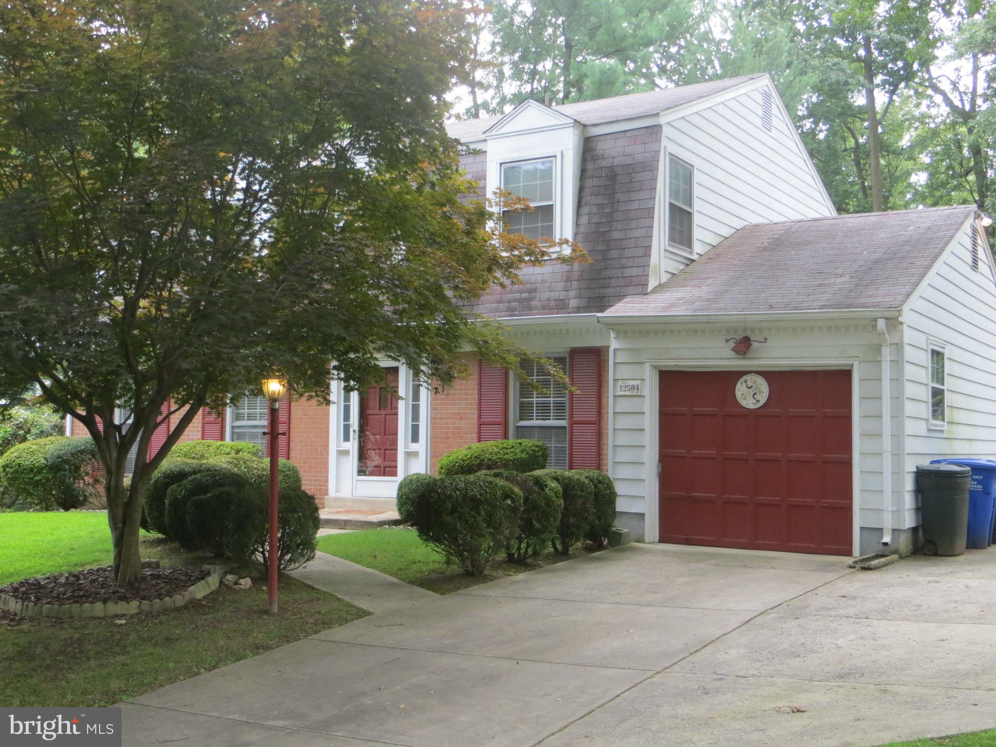 12504 Kuhl Road Silver Spring, MD 20902 - Photo 14 of 27 a front view of a house with a yard and garage