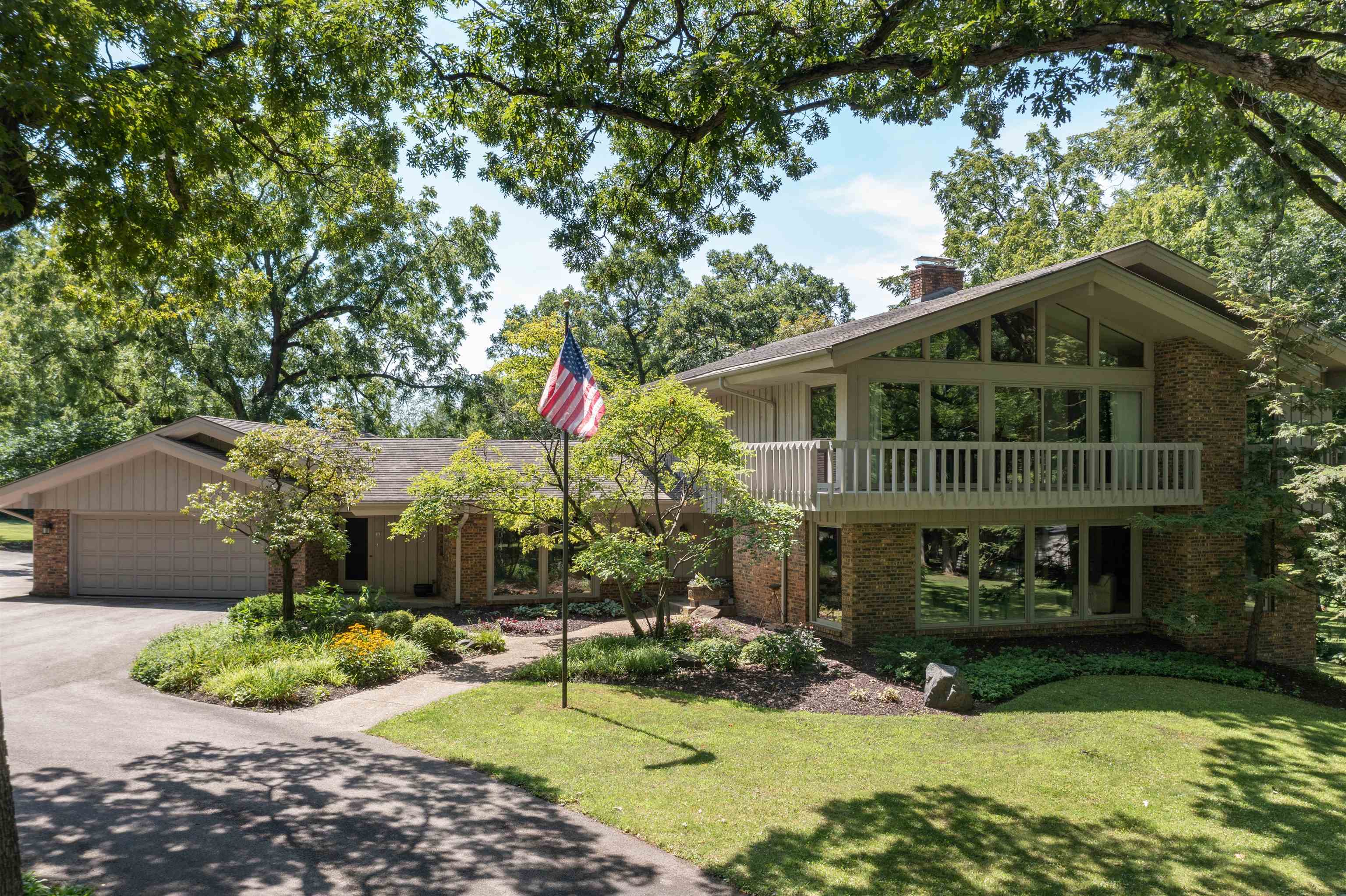 a front view of a house with a yard and shrubs