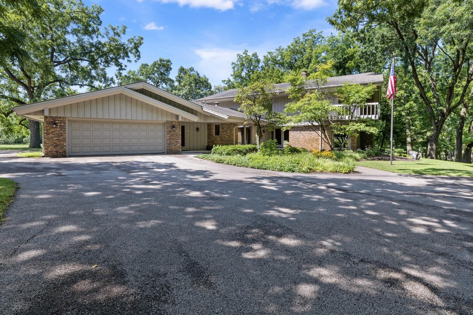 6351 Harlem Road Loves Park, IL 61111 - Photo 2 of 74 a backyard of a house with a garden and plants