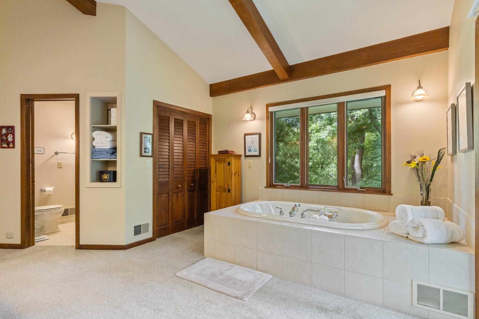 6351 Harlem Road Loves Park, IL 61111 - Photo 34 of 74 a spacious bathroom with a tub and a large mirror
