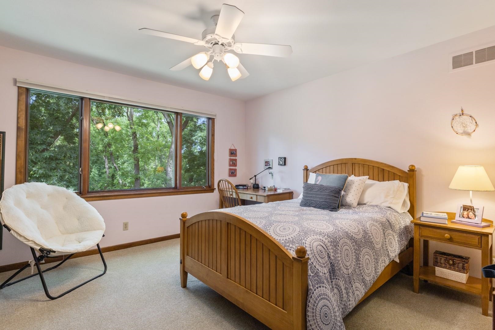 6351 Harlem Road Loves Park, IL 61111 - Photo 36 of 74 a bedroom with a bed a table chair and a chandelier