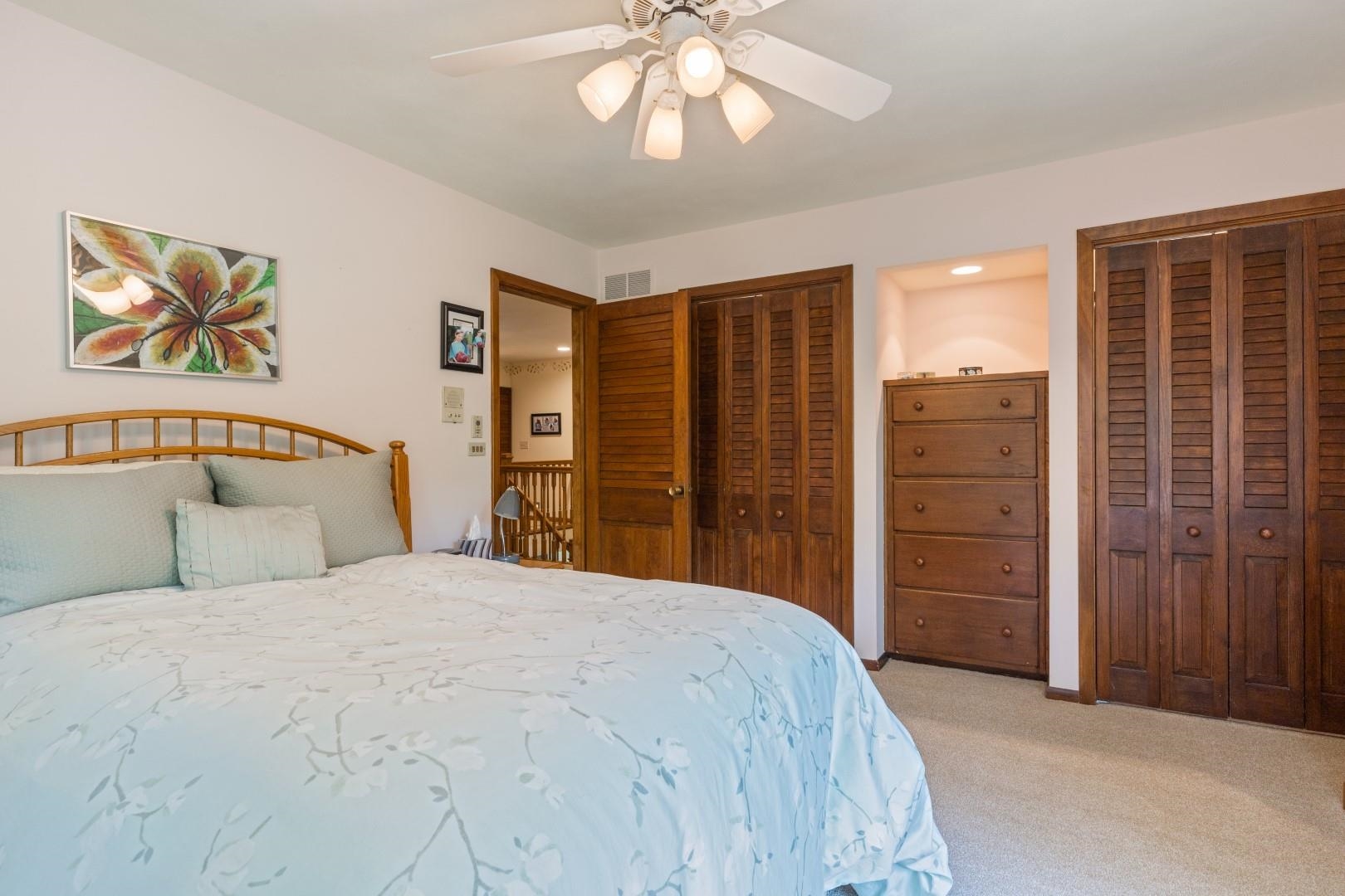 6351 Harlem Road Loves Park, IL 61111 - Photo 38 of 74 a bedroom with a large bed and a chandelier