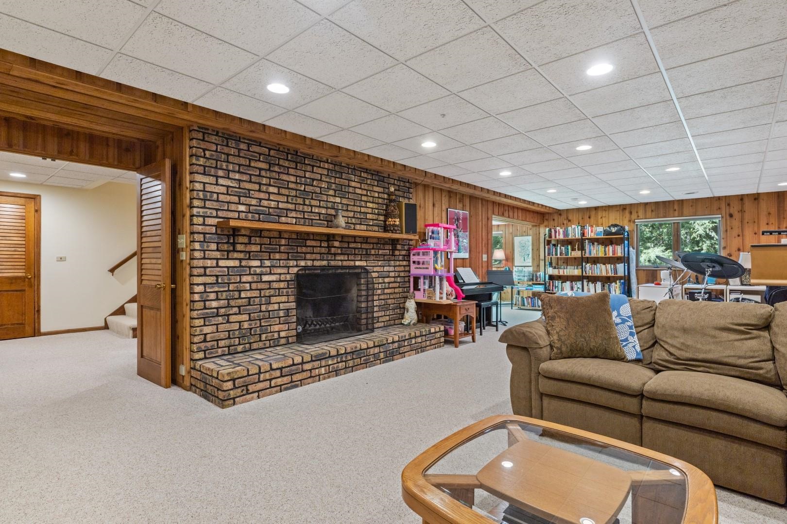 6351 Harlem Road Loves Park, IL 61111 - Photo 44 of 74 a living room with furniture and a fireplace