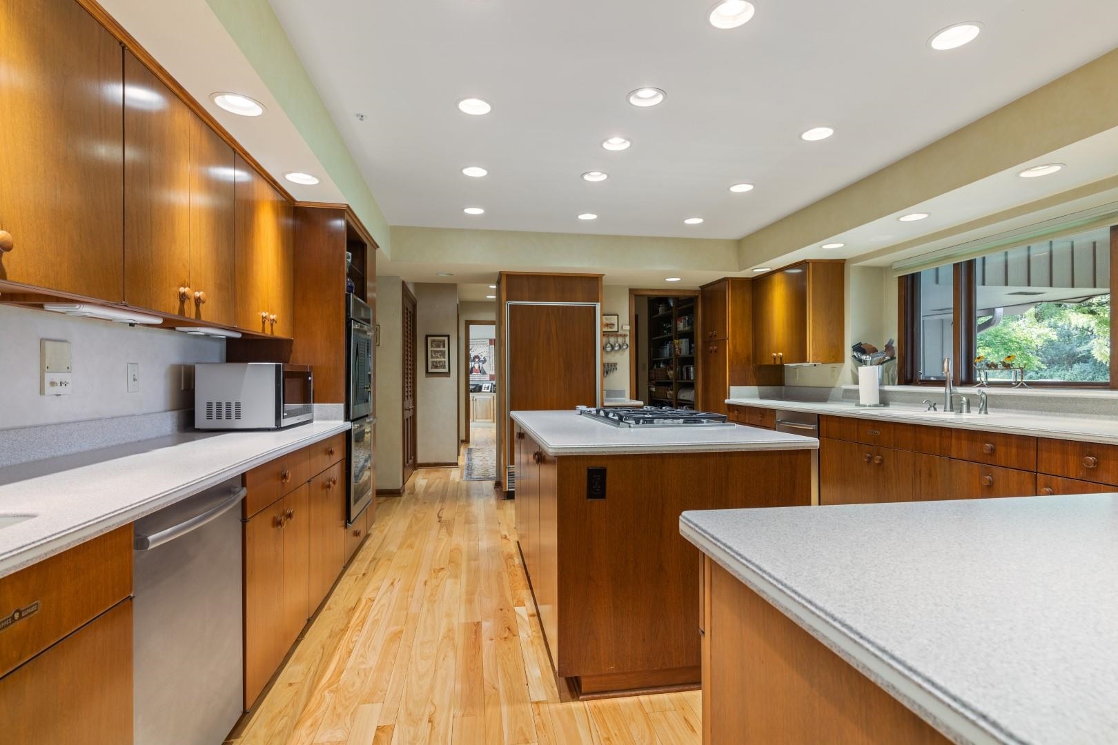 6351 Harlem Road Loves Park, IL 61111 - Photo 5 of 74 a large kitchen with kitchen island a sink stove and a large window