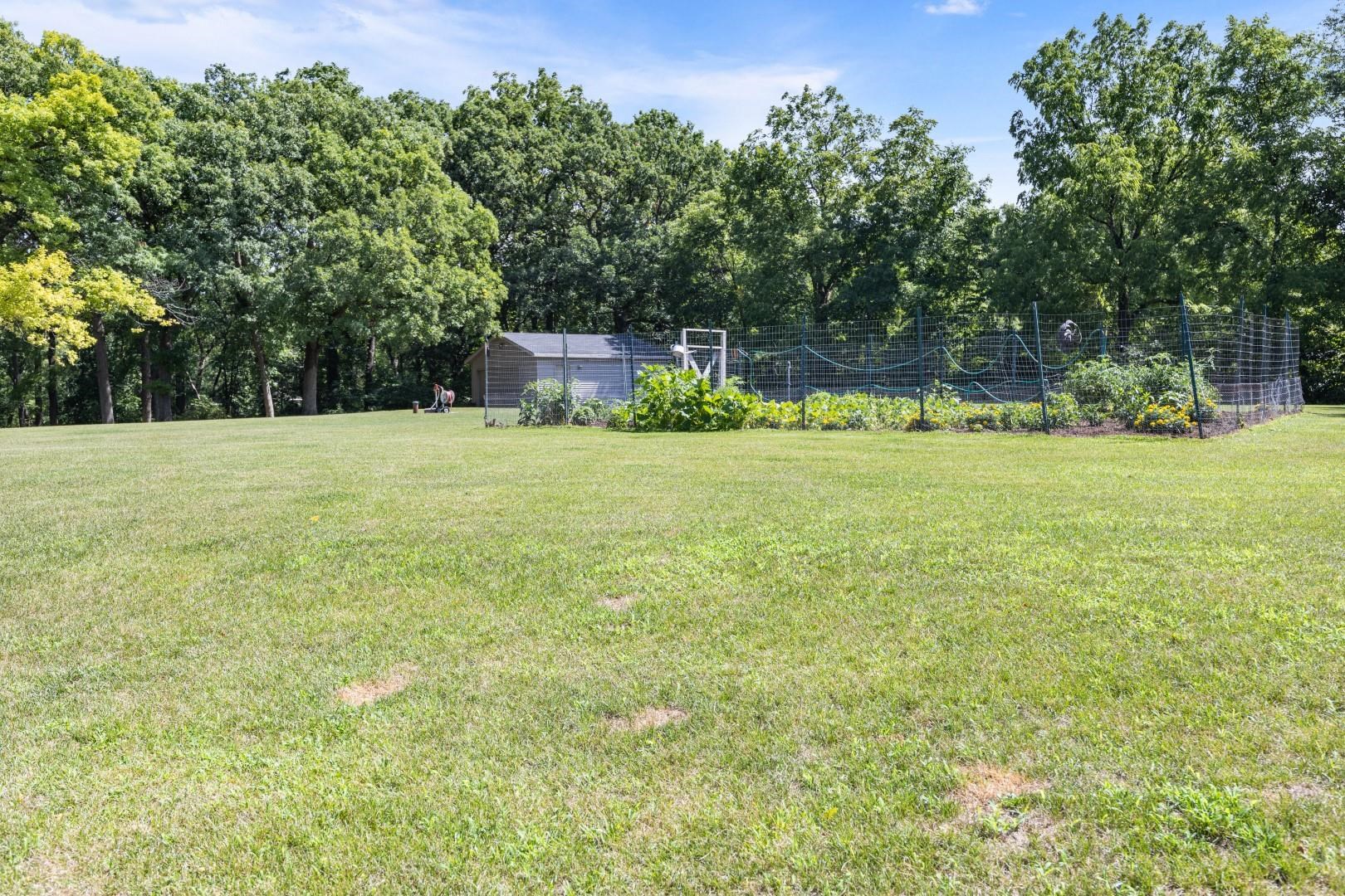 6351 Harlem Road Loves Park, IL 61111 - Photo 57 of 74 a big yard with lots of green space and trees in the background