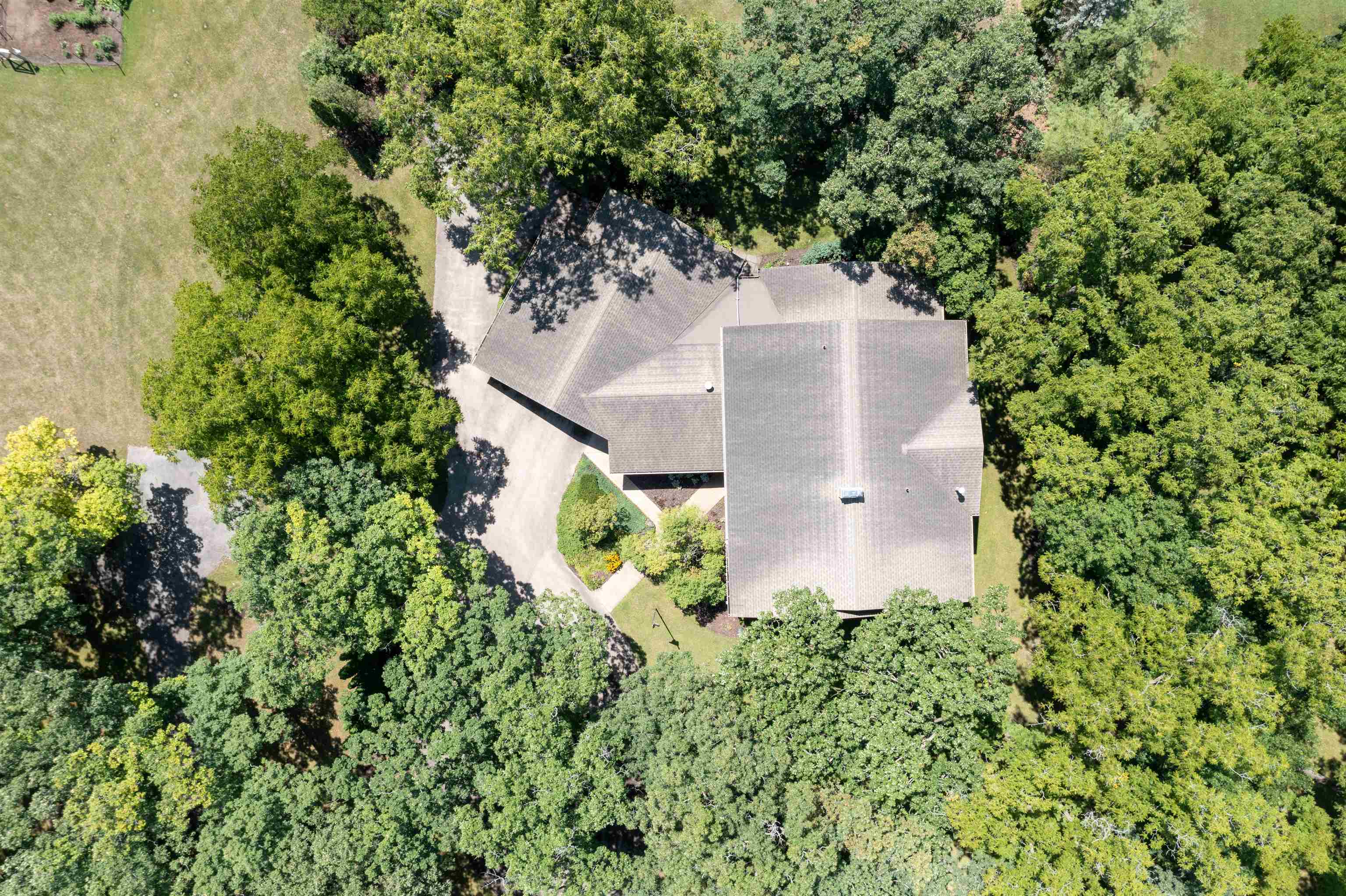 6351 Harlem Road Loves Park, IL 61111 - Photo 67 of 74 an aerial view of a house with a yard and trees all around