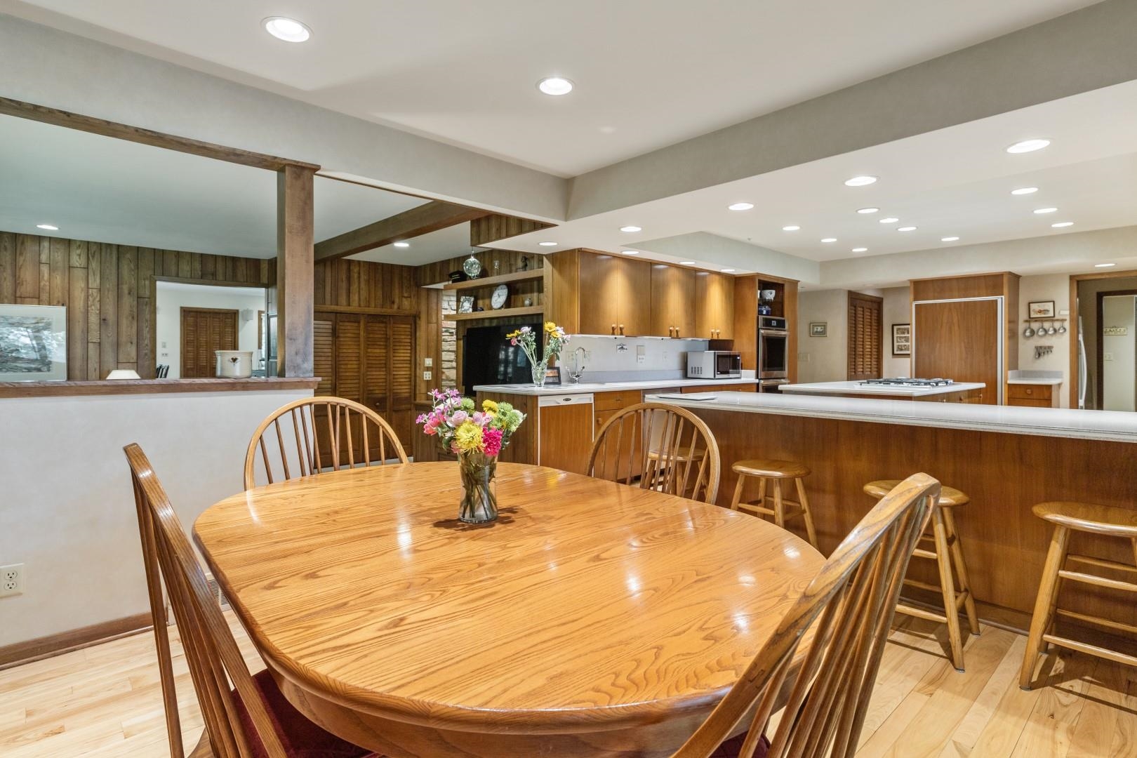 6351 Harlem Road Loves Park, IL 61111 - Photo 9 of 74 a kitchen with stainless steel appliances kitchen island granite countertop a dining table chairs with kitchen island