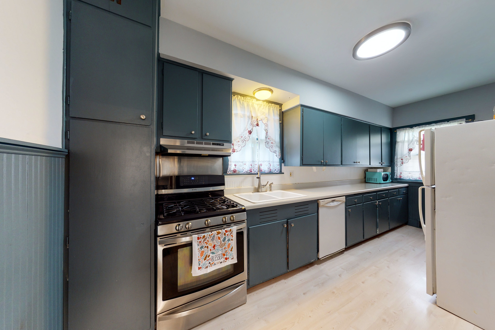 658 Linden Avenue Elgin, IL 60120 - Photo 6 of 28 a kitchen with stainless steel appliances granite countertop a stove a sink and a refrigerator