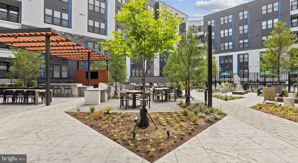 a view of a patio with dining table and chairs with plants