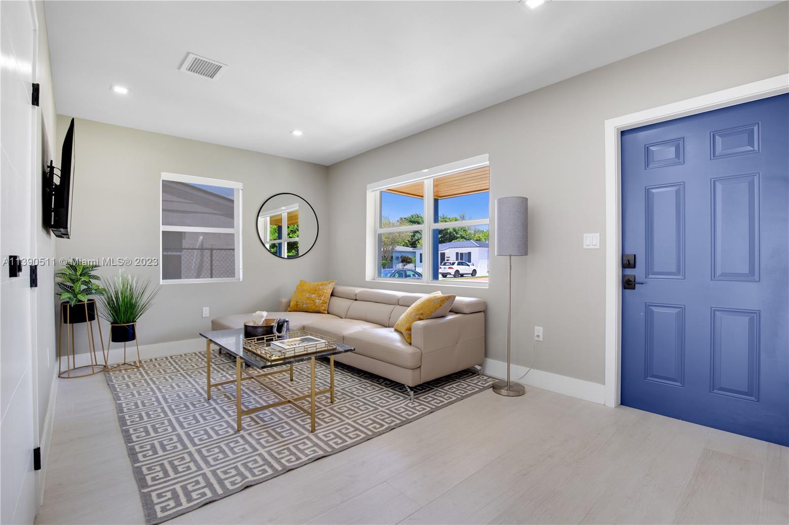 a living room with furniture and wooden floor