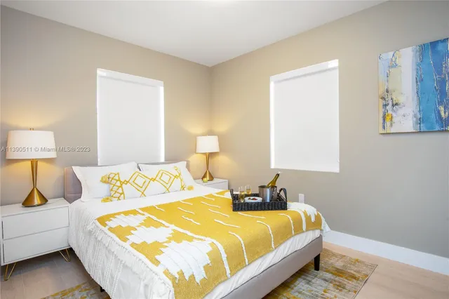 a bedroom with a bed and a flat screen tv