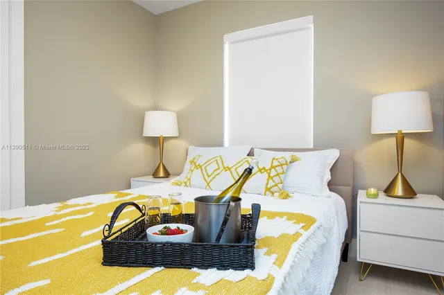 a bedroom with a bed and a lamp