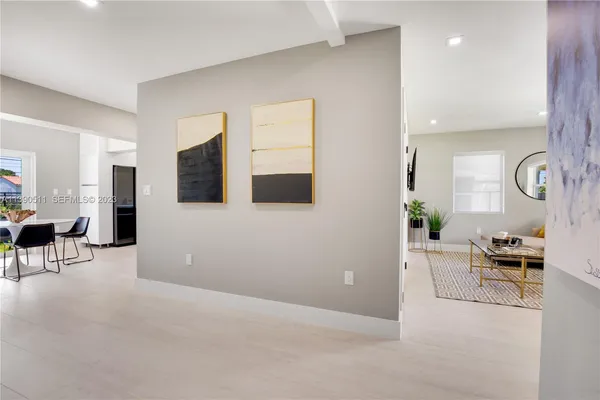 a view of a dining room with furniture and a window