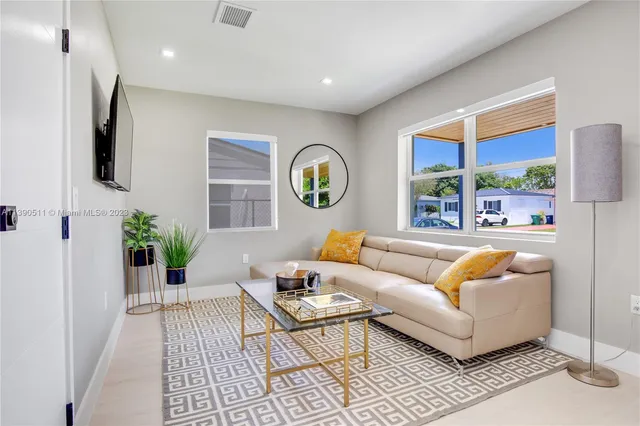 a living room with furniture and a large window