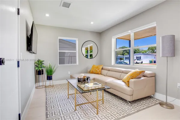 a living room with furniture and a large window