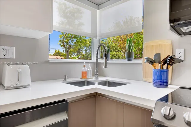 a kitchen with a sink a microwave a stove and refrigerator
