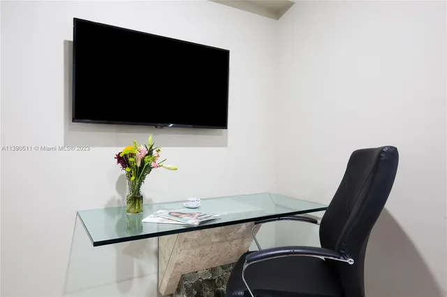 a bedroom with a bed a wall painting on the wall and a shower