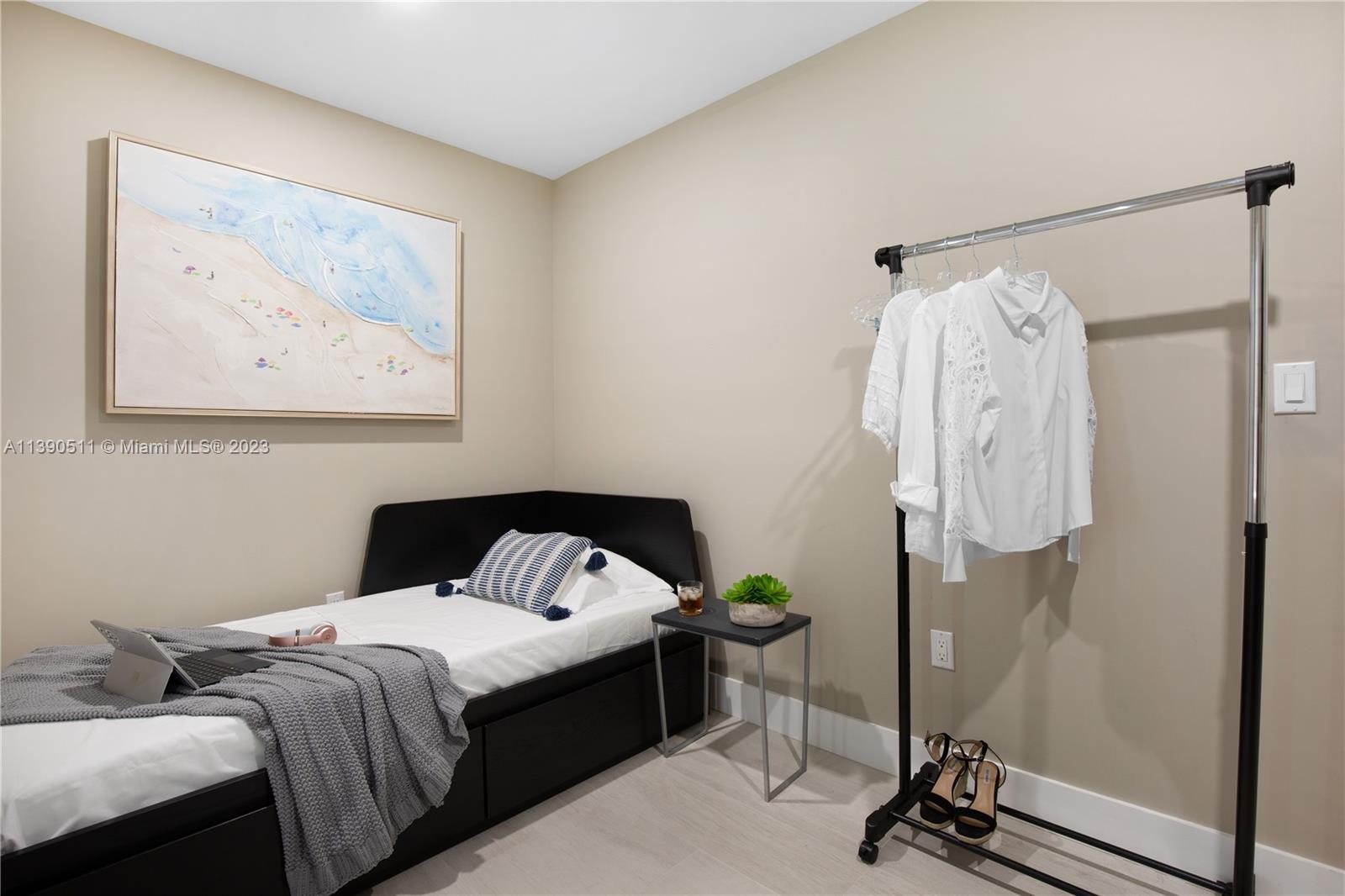 6428 Southwest 23rd Street, Unit 6428 Miami, FL 33155 - Photo 28 of 35 a bedroom with a bed a wall painting on the wall and a shower