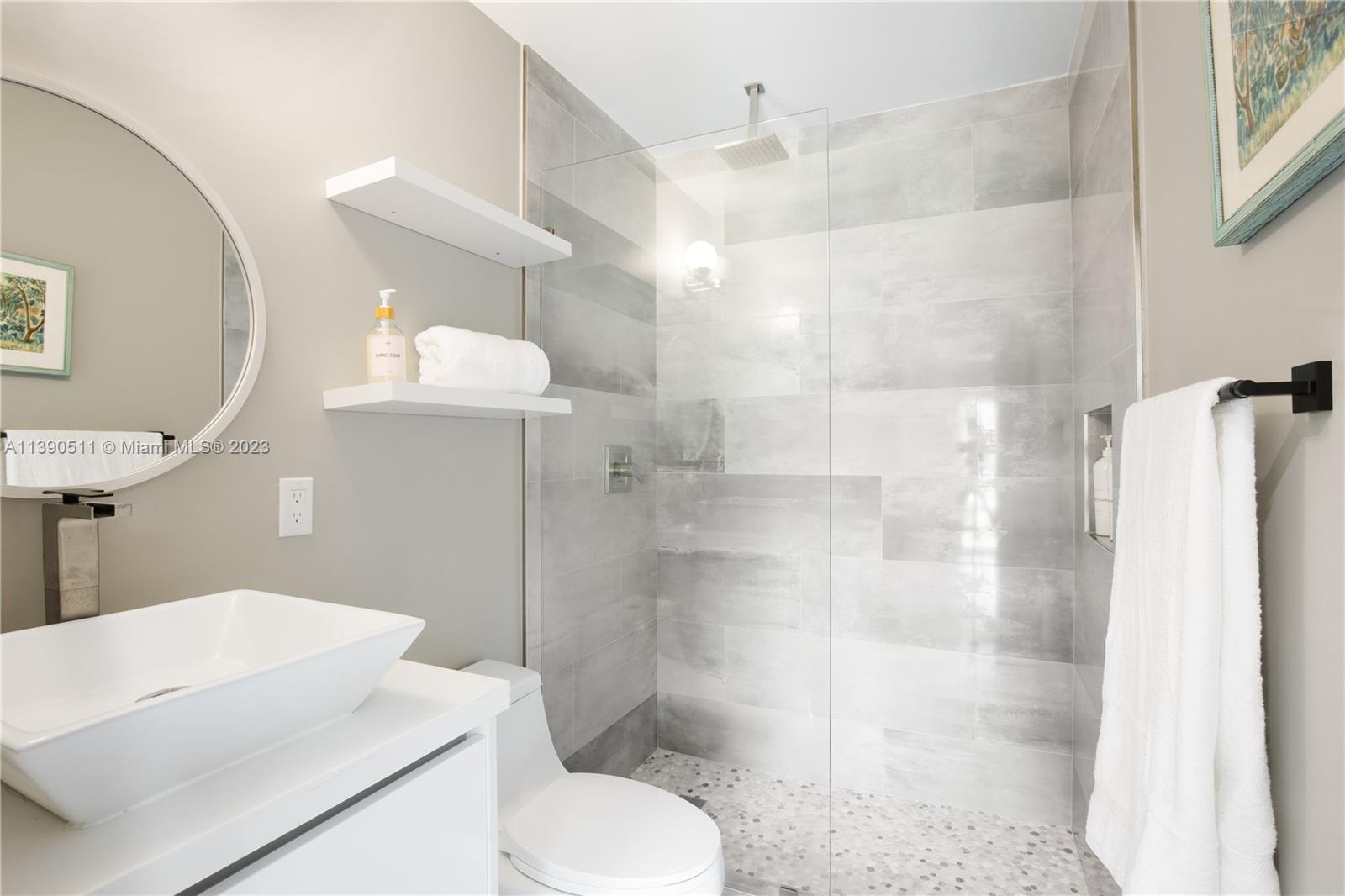 6428 Southwest 23rd Street, Unit 6428 Miami, FL 33155 - Photo 29 of 35 a bathroom with a shower a toilet and a sink