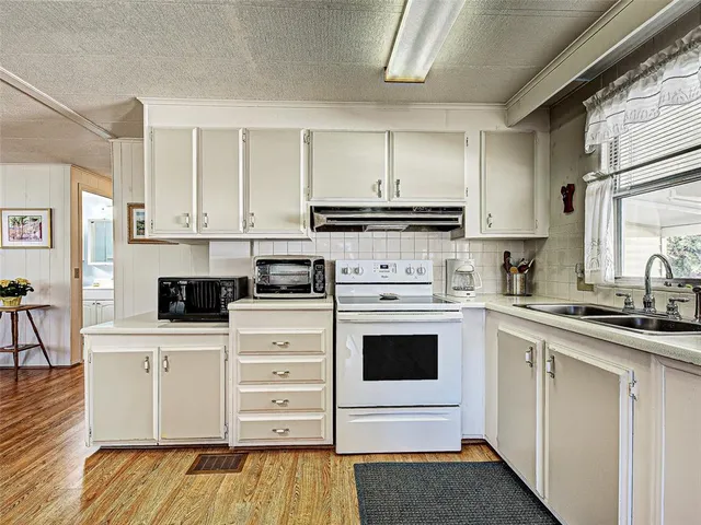 a view of a workspace with furniture and wooden floor