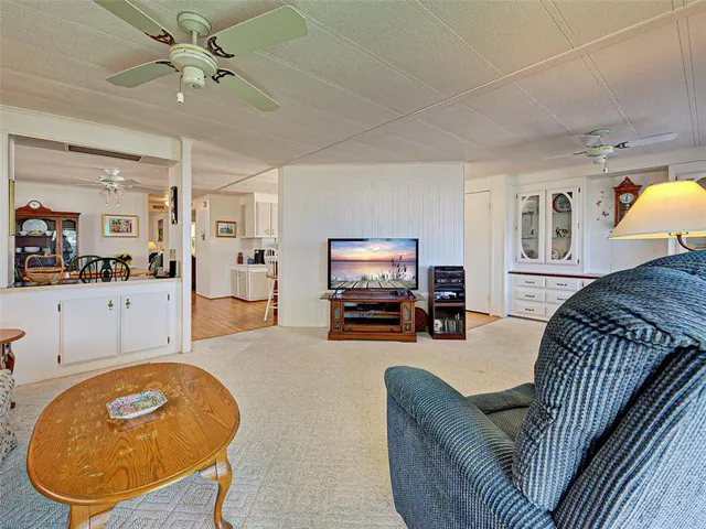 a spacious bedroom with a large bed and a chandelier