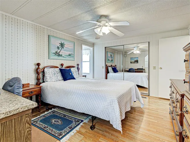 a bedroom with two beds and a lamp on dresser