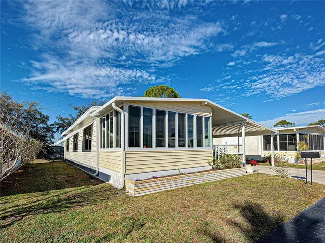 a view of a white house with a yard