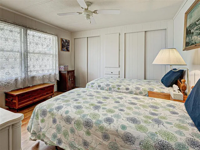 a front view of a house with a garden and trees