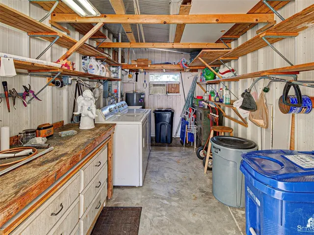 a view of a building with sitting area and garden