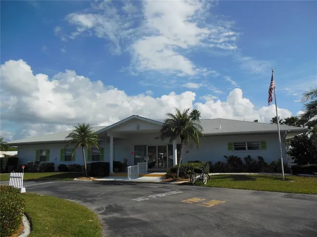 a front view of a house with a yard table and chairs