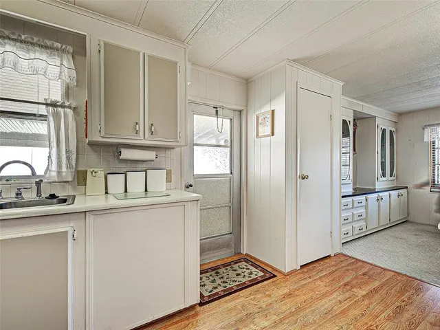 a kitchen with white cabinets and appliances