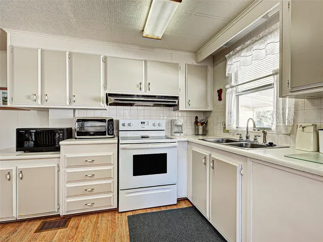 a dining room with furniture a chandelier and wooden floor