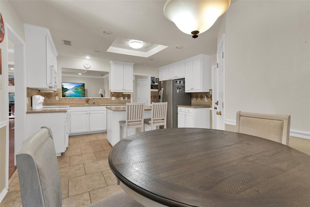 2510 Holiday Street Denison, TX 75020 - Photo 13 of 30 a kitchen with stainless steel appliances a refrigerator and a stove top oven