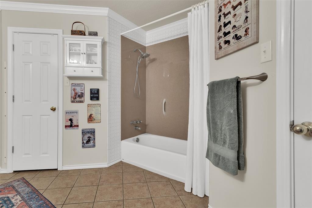 2510 Holiday Street Denison, TX 75020 - Photo 18 of 30 a bathroom with a bathtub and shower