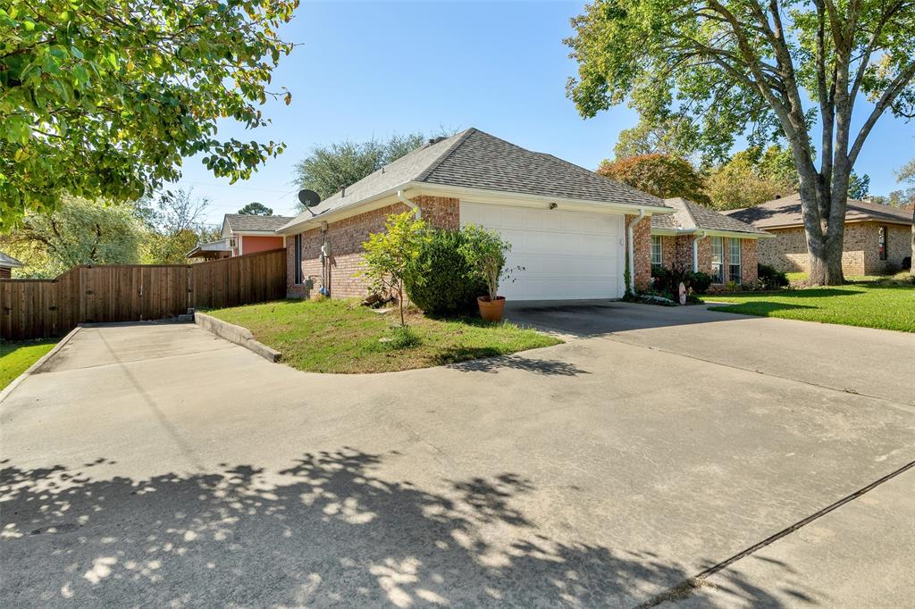 2510 Holiday Street Denison, TX 75020 - Photo 2 of 30 a view of a house with a yard and potted plants