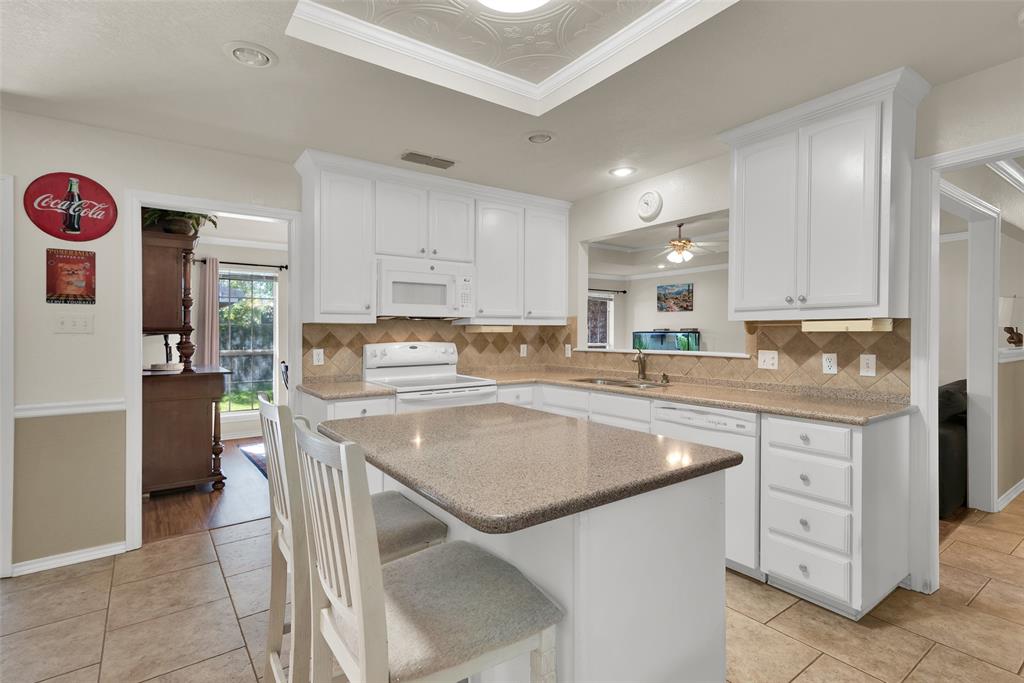 2510 Holiday Street Denison, TX 75020 - Photo 10 of 30 a kitchen with stainless steel appliances granite countertop a sink stove and refrigerator