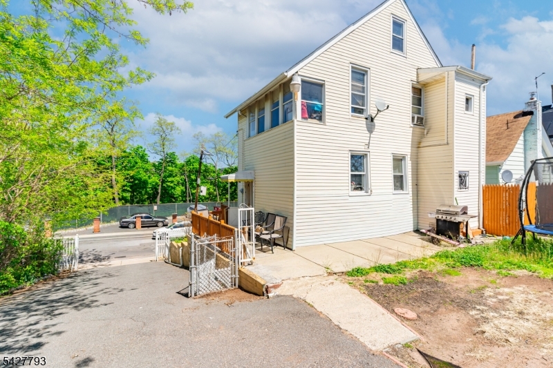 420 Mechanic Street Orange, NJ 07050 - Photo 16 of 18 a view of backyard with a chair and tables