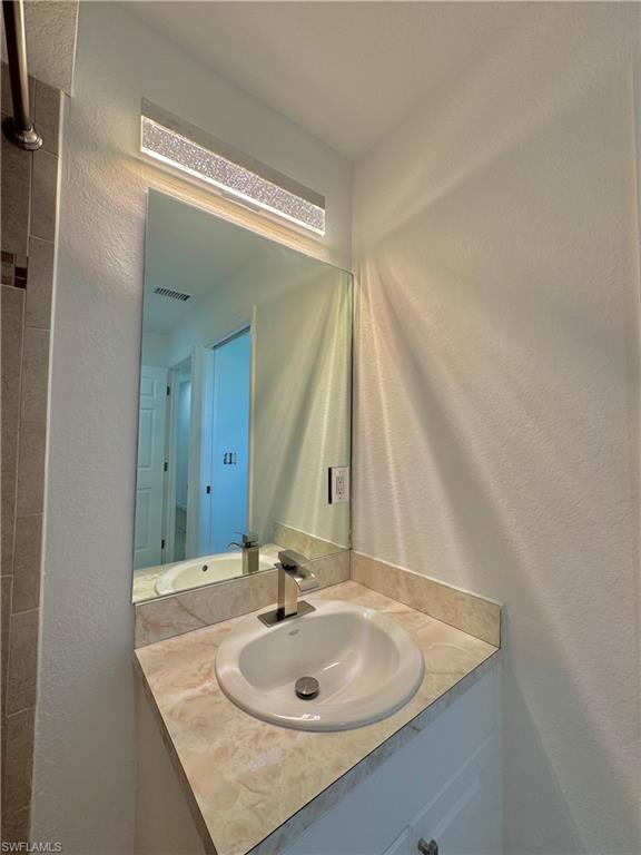 813 Naples Avenue South Lehigh Acres, FL 33974 - Photo 4 of 13 a bathroom with a sink and a mirror
