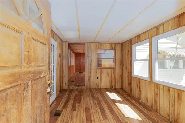a view of a room with wooden floor and windows