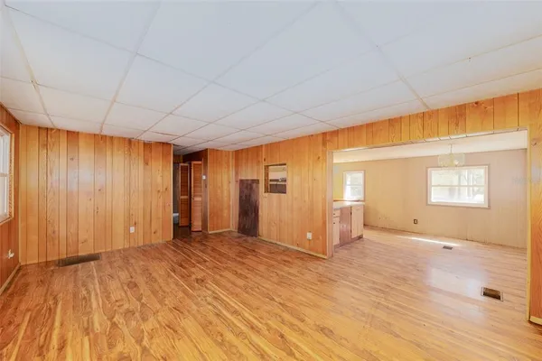a view of an empty room with closet and a window
