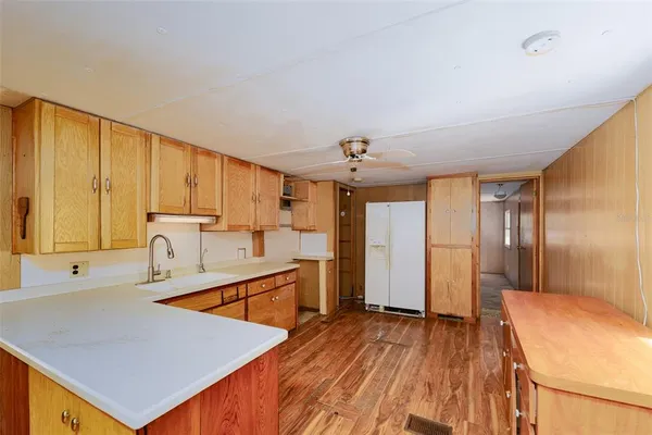 a kitchen with stainless steel appliances granite countertop a sink a stove and a refrigerator