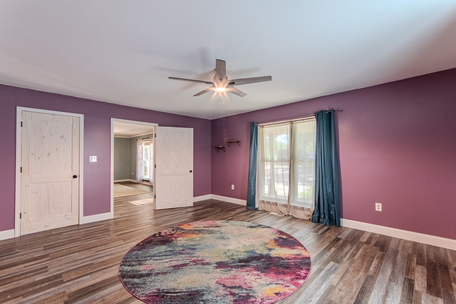 3280 Ramer Selmer Road Ramer, TN 38367 - Photo 11 of 23 a view of a room with wooden floor and a ceiling fan