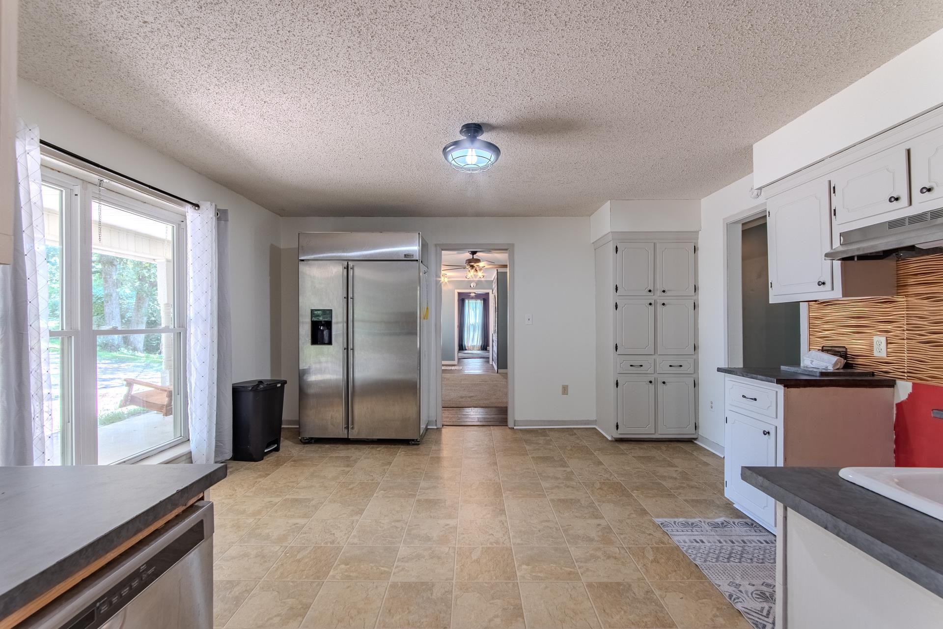3280 Ramer Selmer Road Ramer, TN 38367 - Photo 9 of 23 a large white kitchen with stainless steel appliances granite countertop a refrigerator and a stove